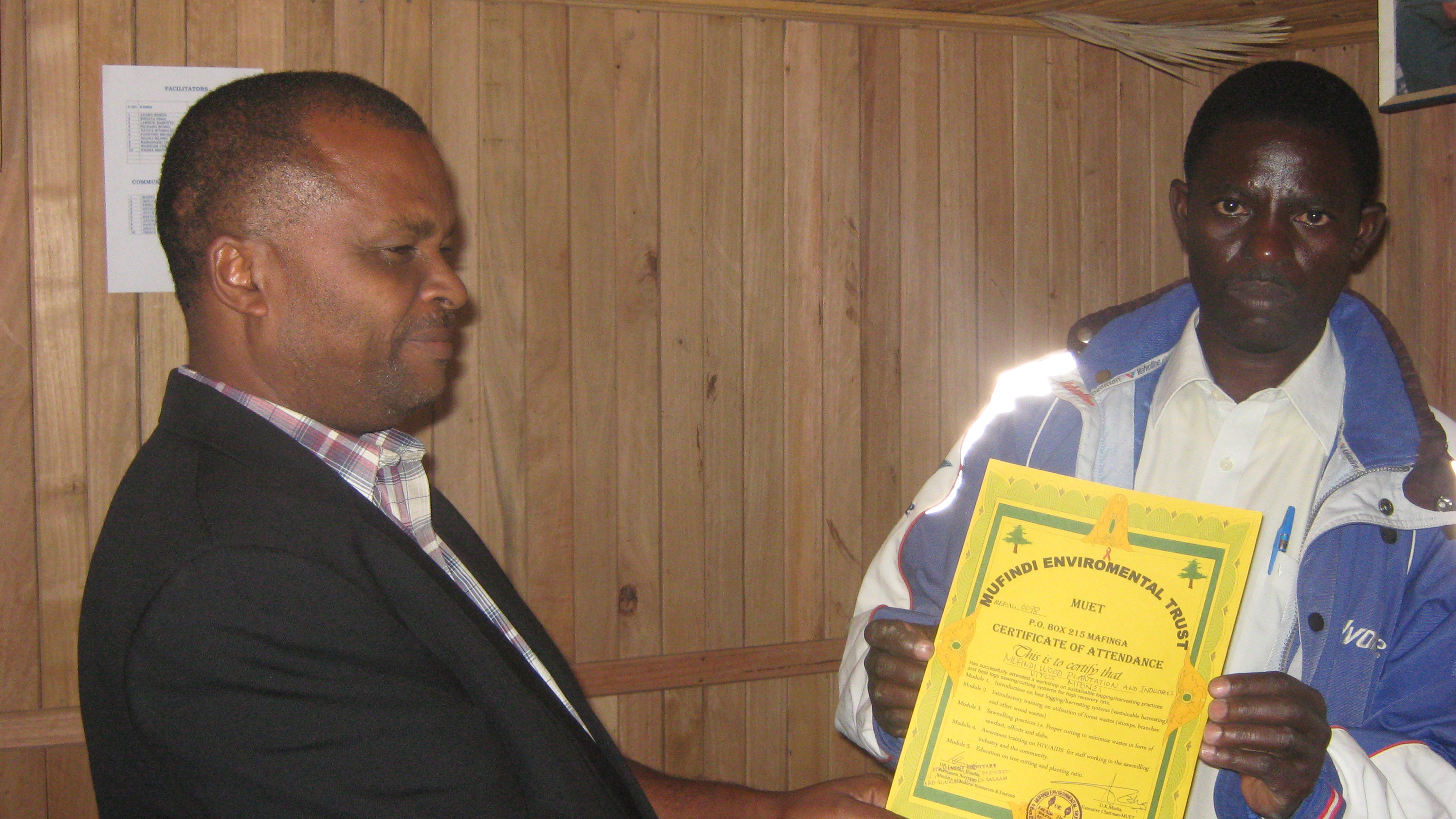 Executive Chairman Muet presenting the certificate to Vitus Mponzi