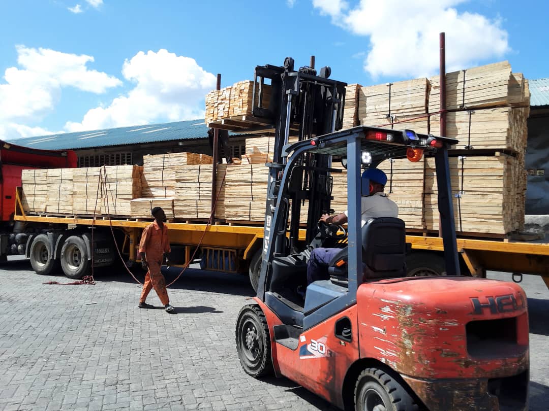 pine_pallet_wood_from_the_company_Mufindi_wood_plantation_and_industries_ltd_being_unloaded_in_a_car_to_be_loaded_into_a_container_to_go_abroad.
